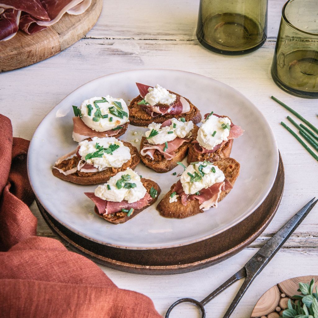 Sundried Tomato Pesto crostini with prosciutto & marinaded goats cheese