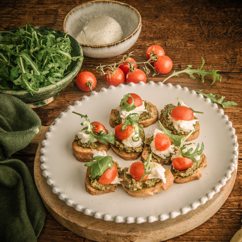 Classic Pesto crostini with tomato, buffalo mozzarella & rocket